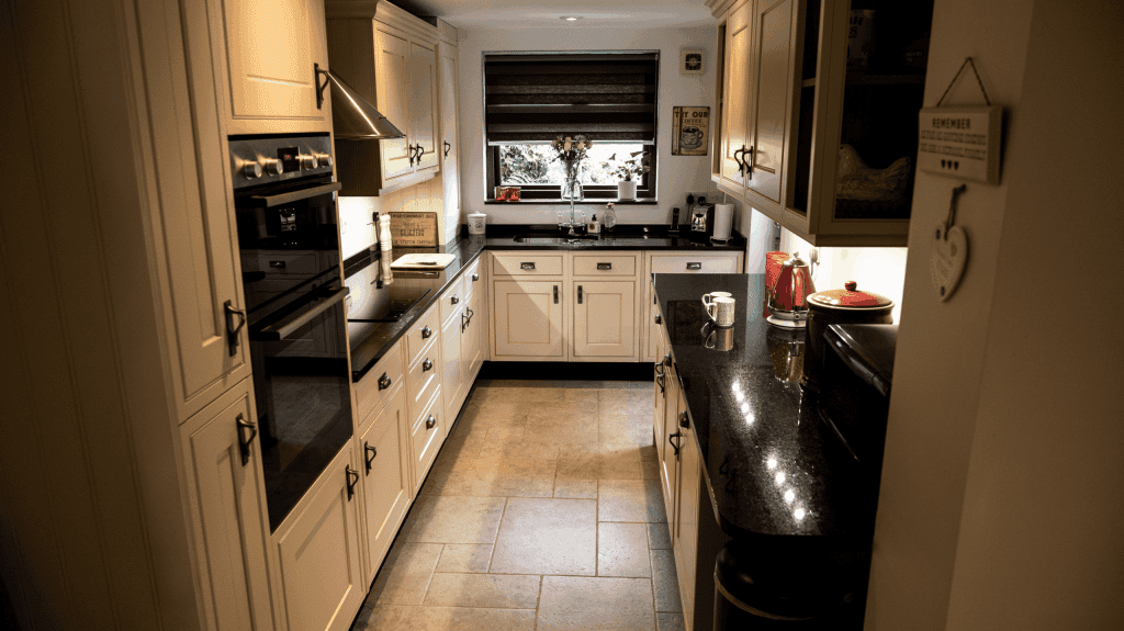 Wide view of a traditional kitchen with Star Galaxy Granite worktops, showing the long perimeter run, sink area and polished reflective finish.