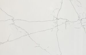 Close-up of White Macaubus Quartz showing fine grey veining across a bright white surface