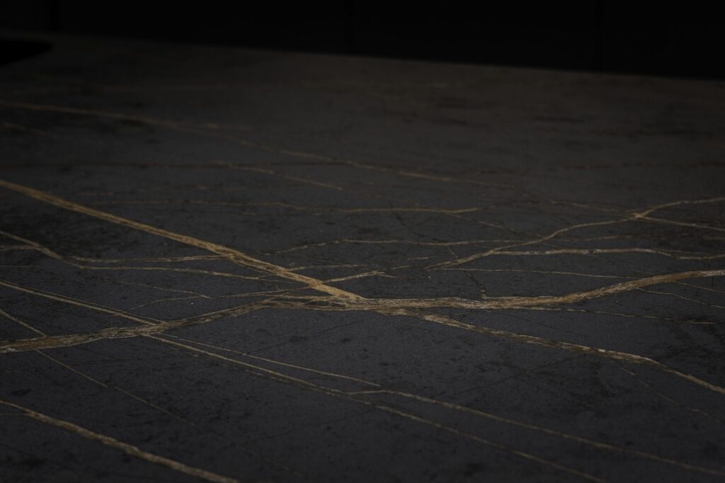 Close-up of Laurent Porcelain worktop surface showing a dark porcelain finish with fine gold veining.