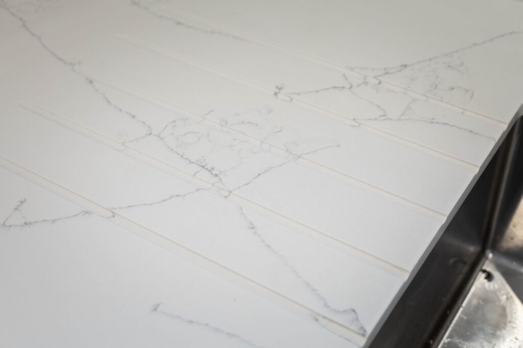 White Macaubus Quartz worktop close-up showing delicate grey veining and a clean white finish