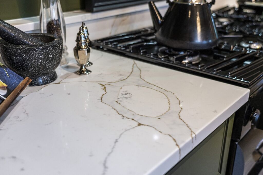 Gold Calacatta worktop with hob cut out displaying bold warm veining