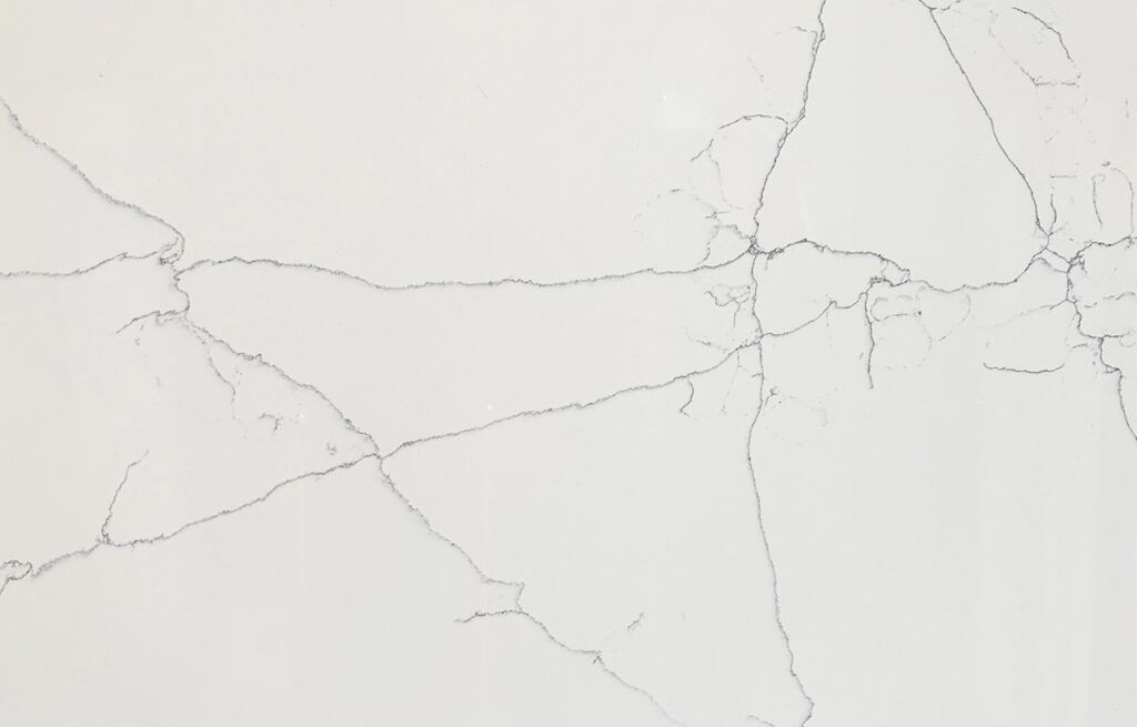 Close-up of White Macaubus Quartz showing fine grey veining across a bright white surface