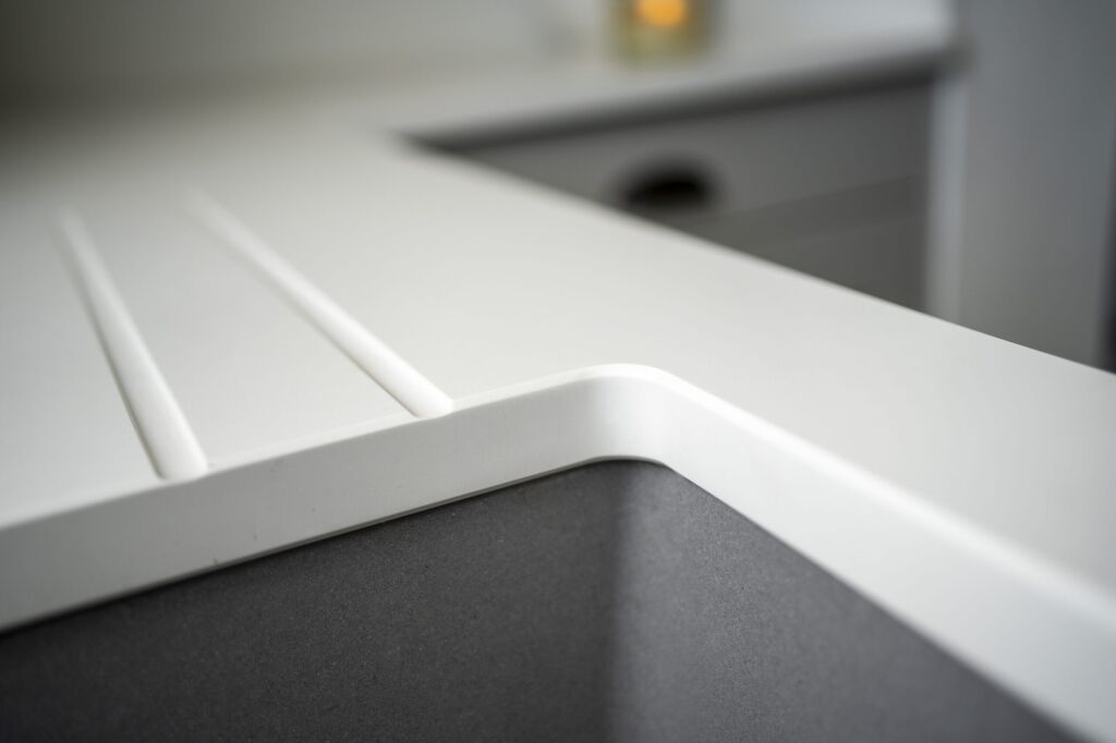 Classic White Quartz worktop close-up showing an inset sink cut-out with clean squared edges and smooth finish