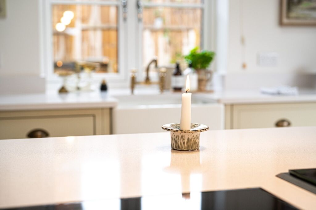 Ice White Quartz worktop surface in a bright kitchen with a smooth white finish and soft background styling