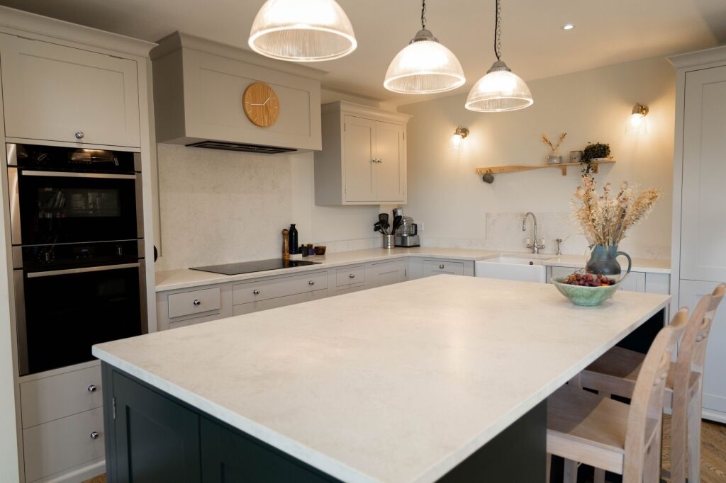 White Concrete Quartz island worktop in a light kitchen showing smooth surface finish and clean edge lines