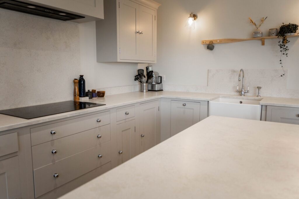 White Concrete Quartz island worktop view looking down the length of the surface in a bright kitchen layout