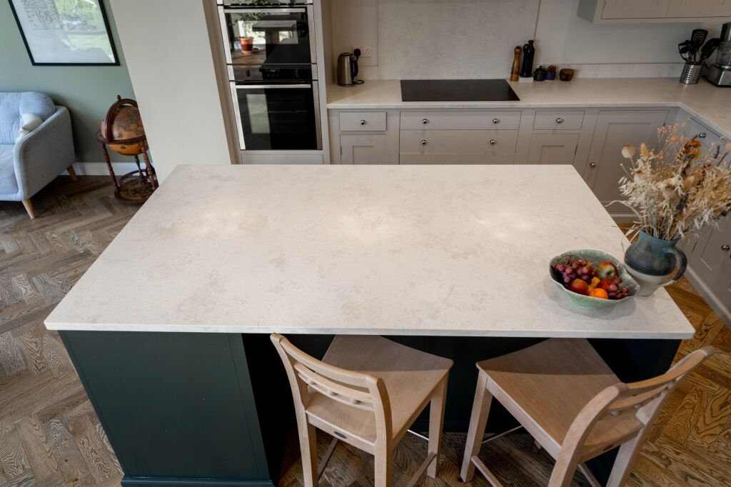 White Concrete Quartz island worktop with seating overhang and soft concrete-effect finish in a modern kitchen