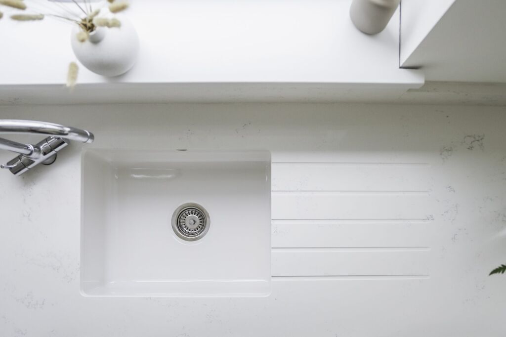 Bluetta Carrara Quartz sink area close-up showing a smooth white surface and inset sink detail