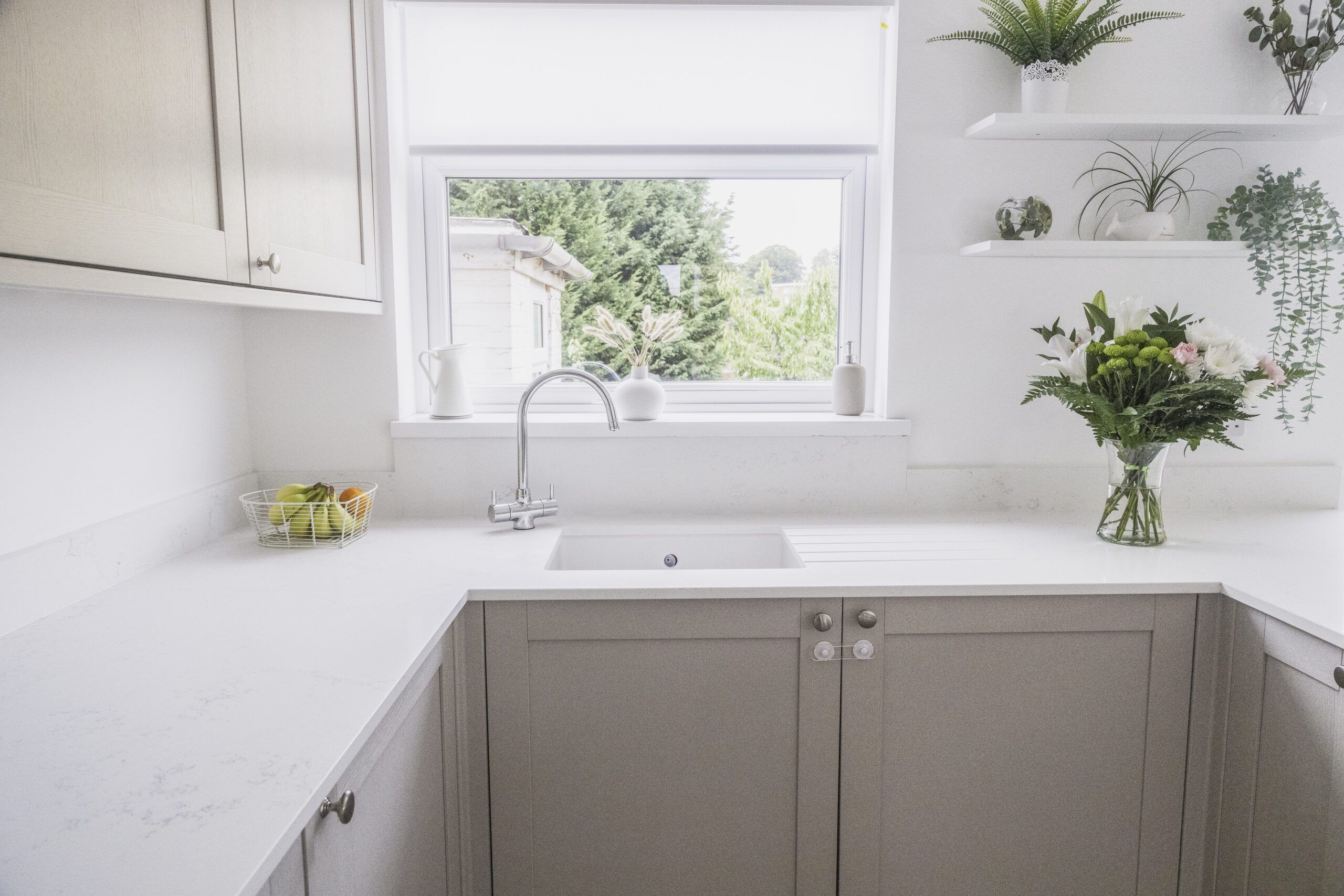 Bluetta Carrara Quartz sink run by a window showing a smooth white surface and clean finish