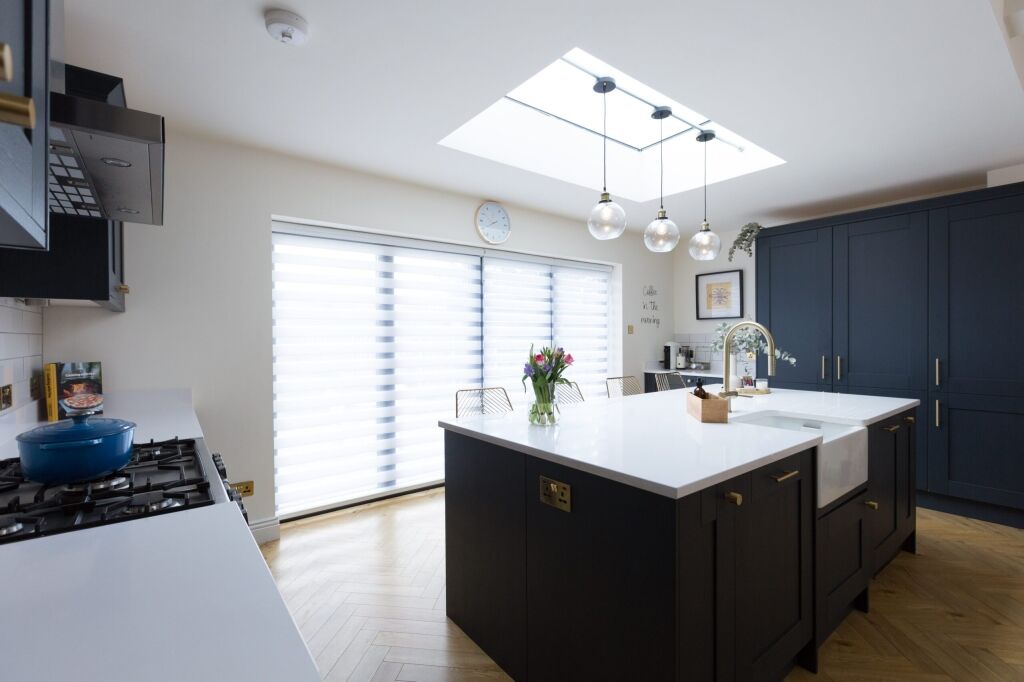 Blanco Zeus Quartz island worktop in an open-plan kitchen with bright white surface and pendant lights above