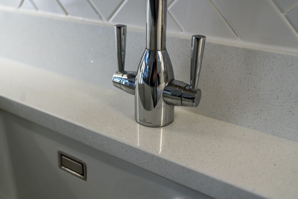 Chrome tap fitted onto Aspen Shimmer Quartz worktops in a modern kitchen