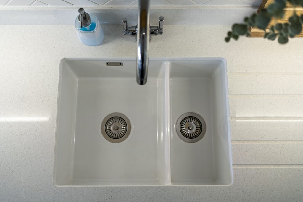 Top view of a white double sink set into Aspen Shimmer Quartz worktops