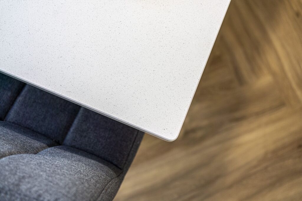Aspen Shimmer Quartz worktop edge above upholstered seating in a modern kitchen