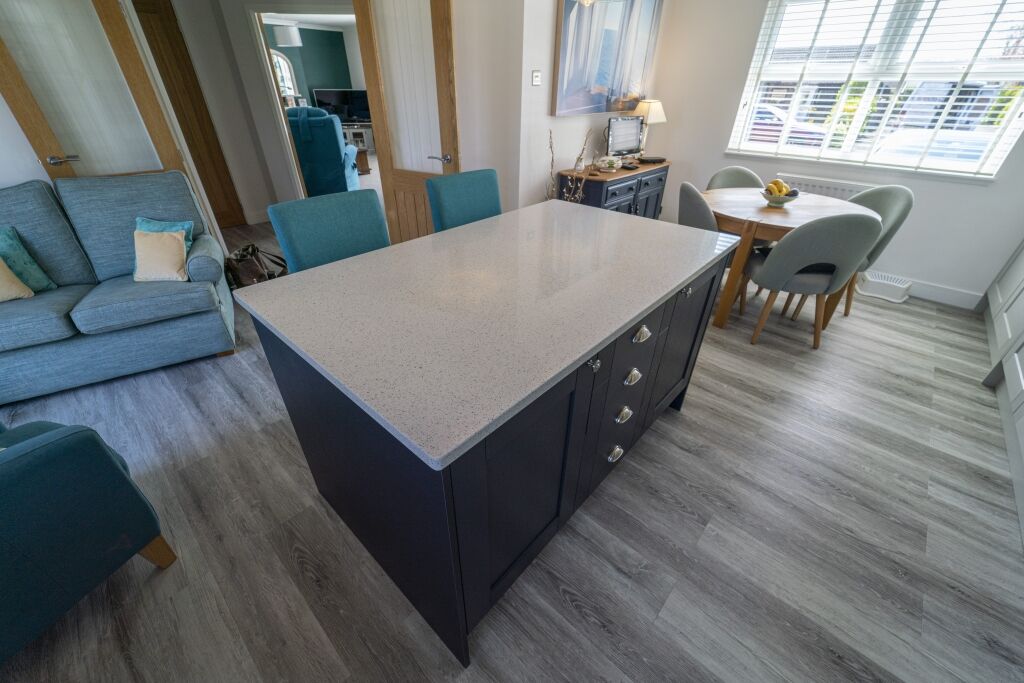 White Starlight Quartz island corner in a modern kitchen with blue seating