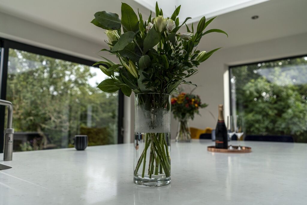 Carrara Quartz worktop beside large window with flower vase