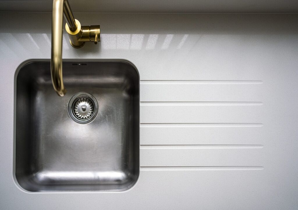 Top-down view of an Imperial White Quartz worktop with an inset sink and drainer grooves