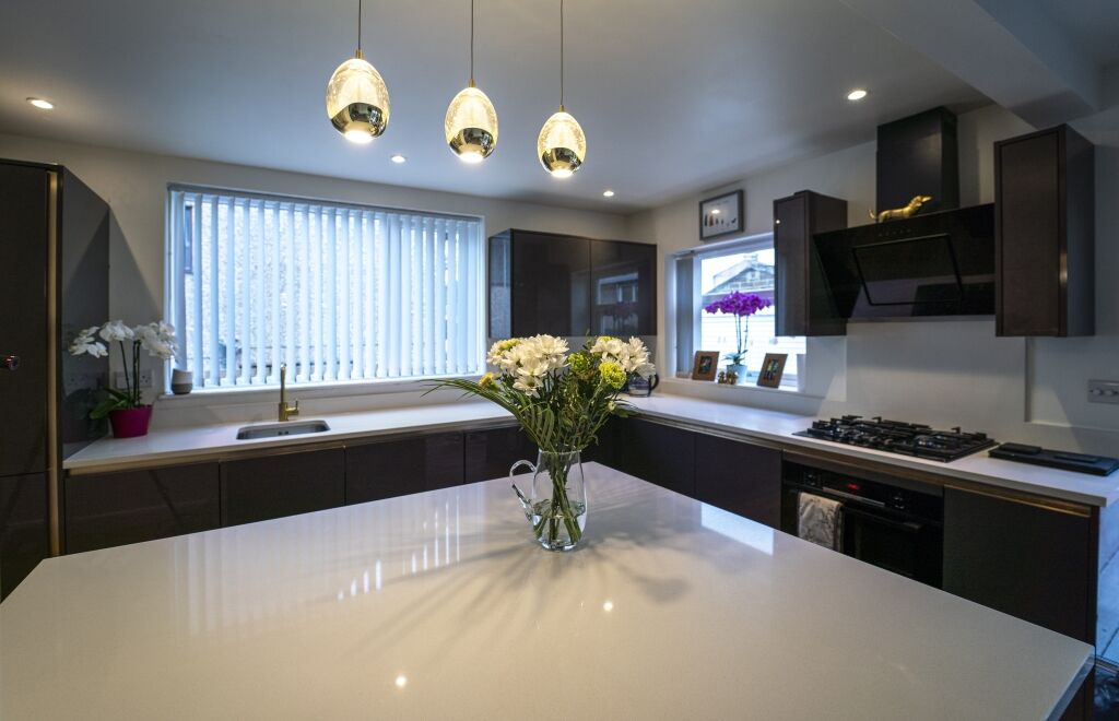 Wide kitchen view featuring an Imperial White Quartz island worktop with a bright, smooth finish