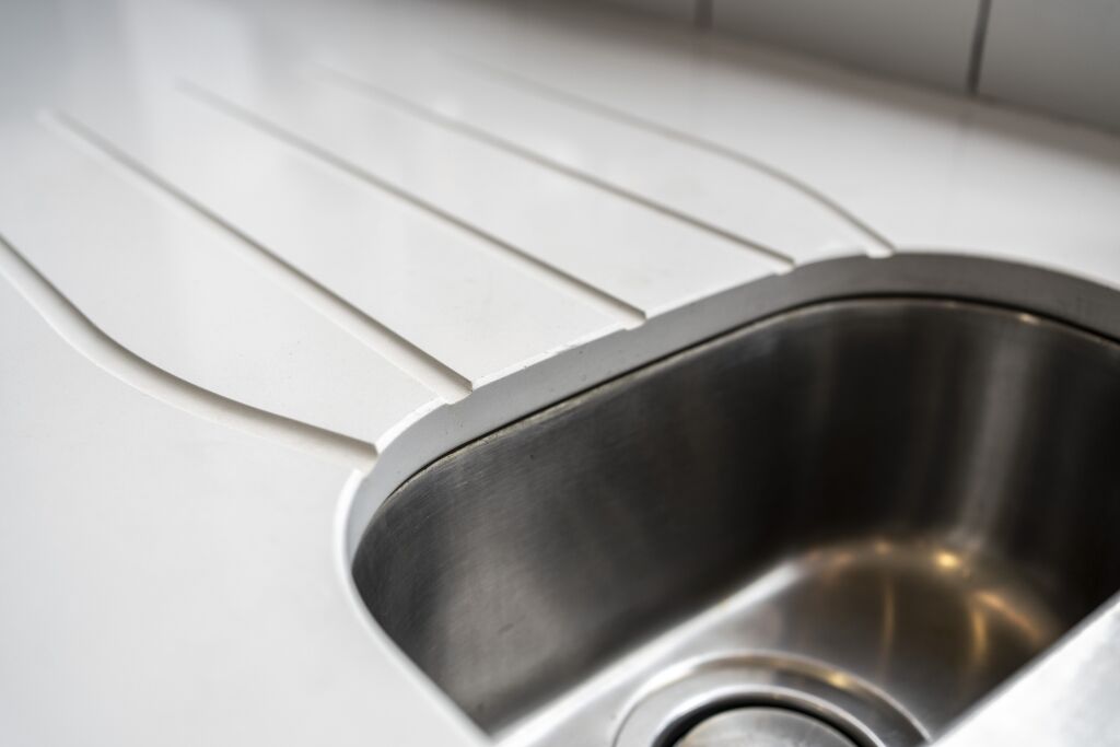Blanco Zeus Quartz drainer grooves and sink close-up showing clean channels formed into the white worktop surface