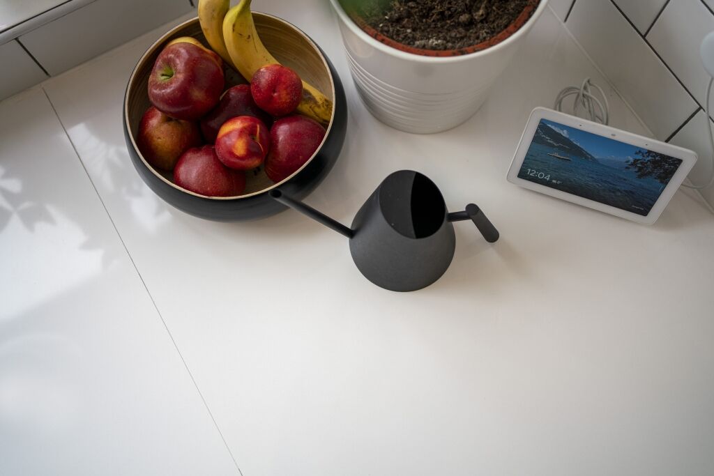 Blanco Zeus Quartz worktop close-up showing a crisp white surface with subtle join lines beside kitchen items