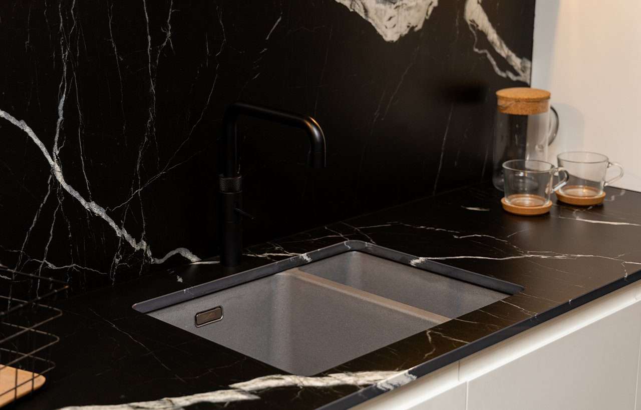 Black Mirage Porcelain sink area with white veining and integrated cut-out