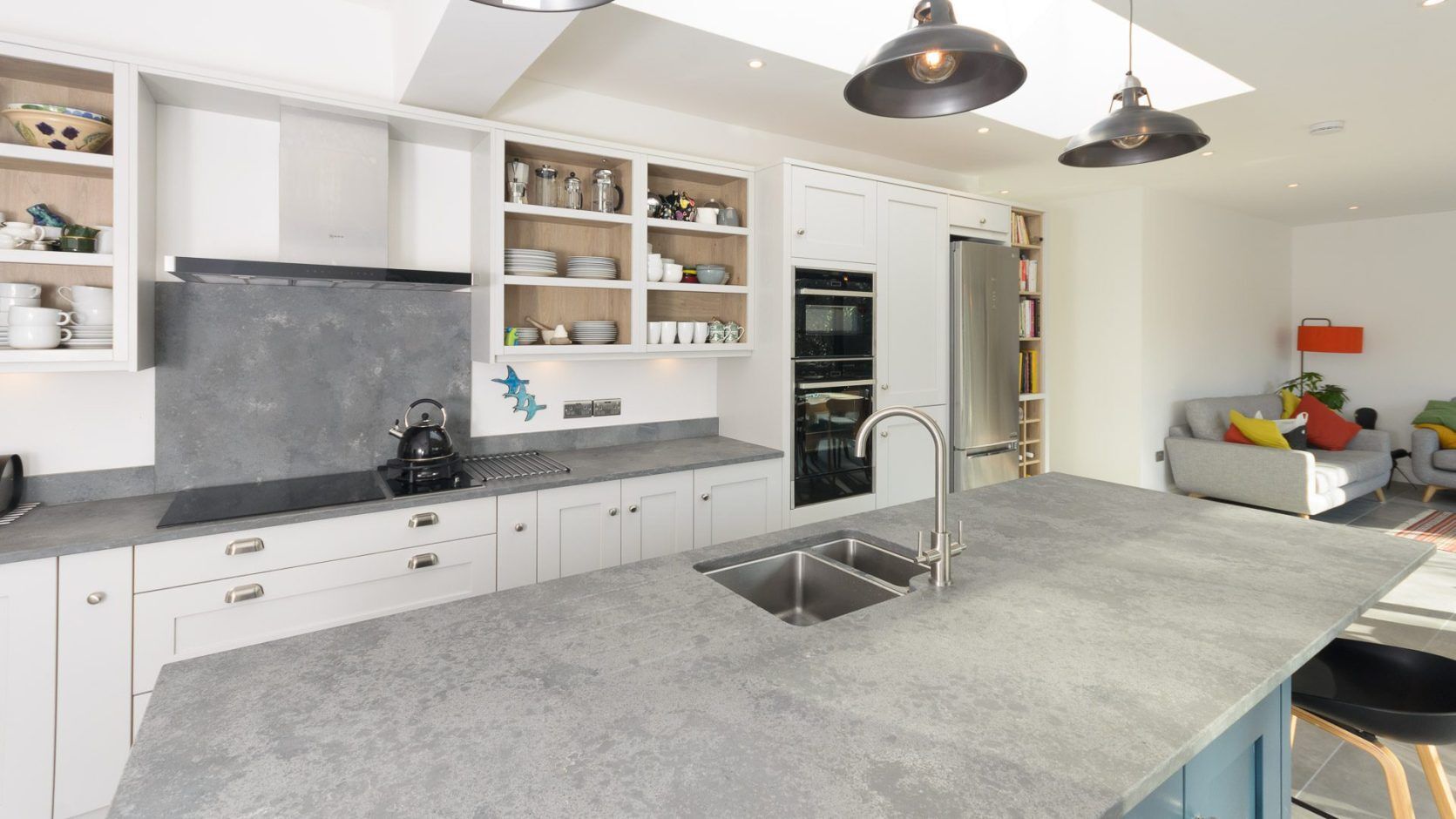 Grey Concrete Quartz worktop with double bowl sink cut-out and chrome tap in a bright modern kitchen