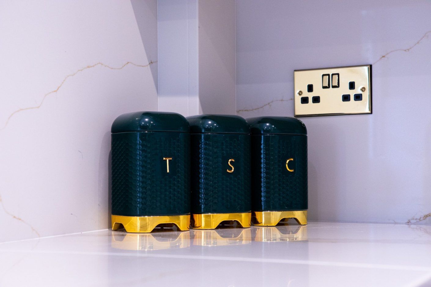 Britannicca Calacatta Quartz worktop styling shelf detail with kitchen canisters against a light surface background