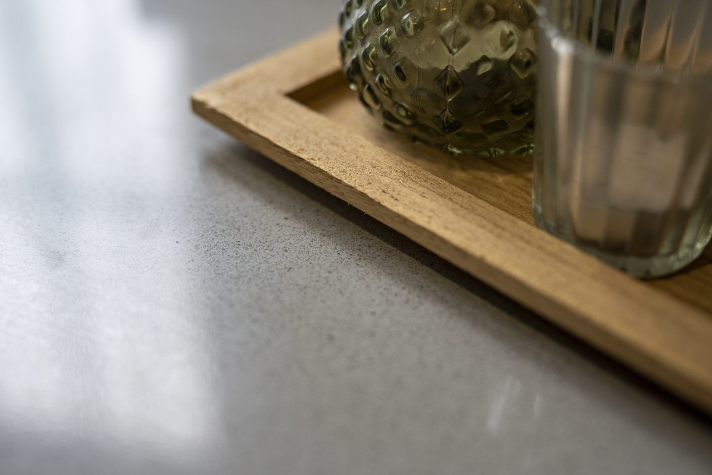 Carnie Quartz worktop close-up showing fine speckle texture beside a wooden tray on the surface