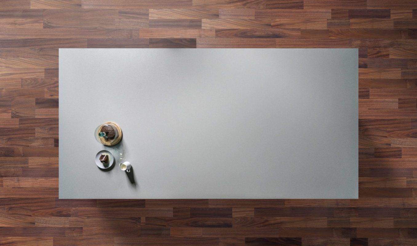 Carnie Quartz worktop shown from above with fine speckle pattern across a light grey surface on a wood floor setting