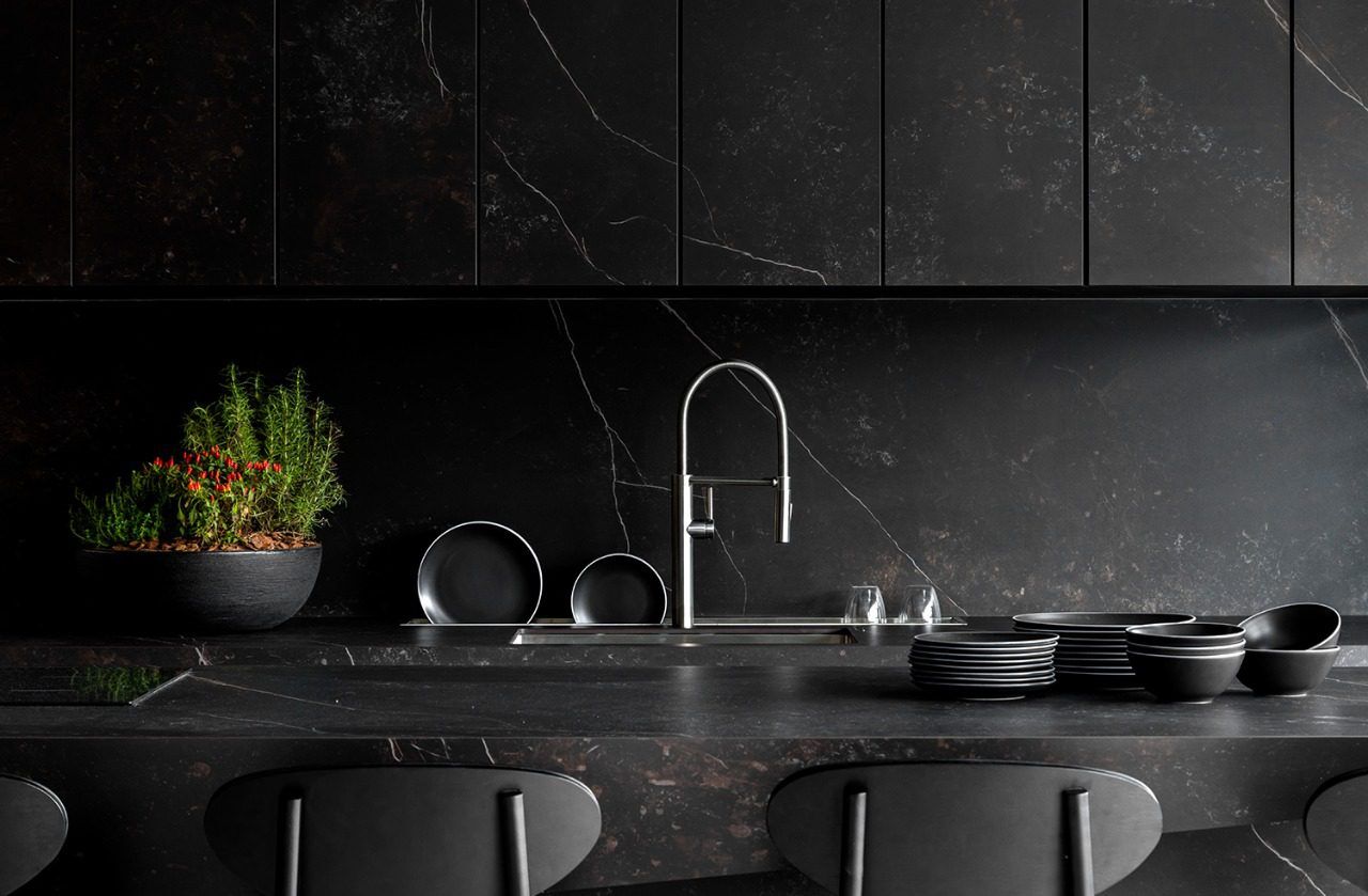 Kelya Porcelain dark worktop run with integrated sink, chrome tap and matching full height splashback