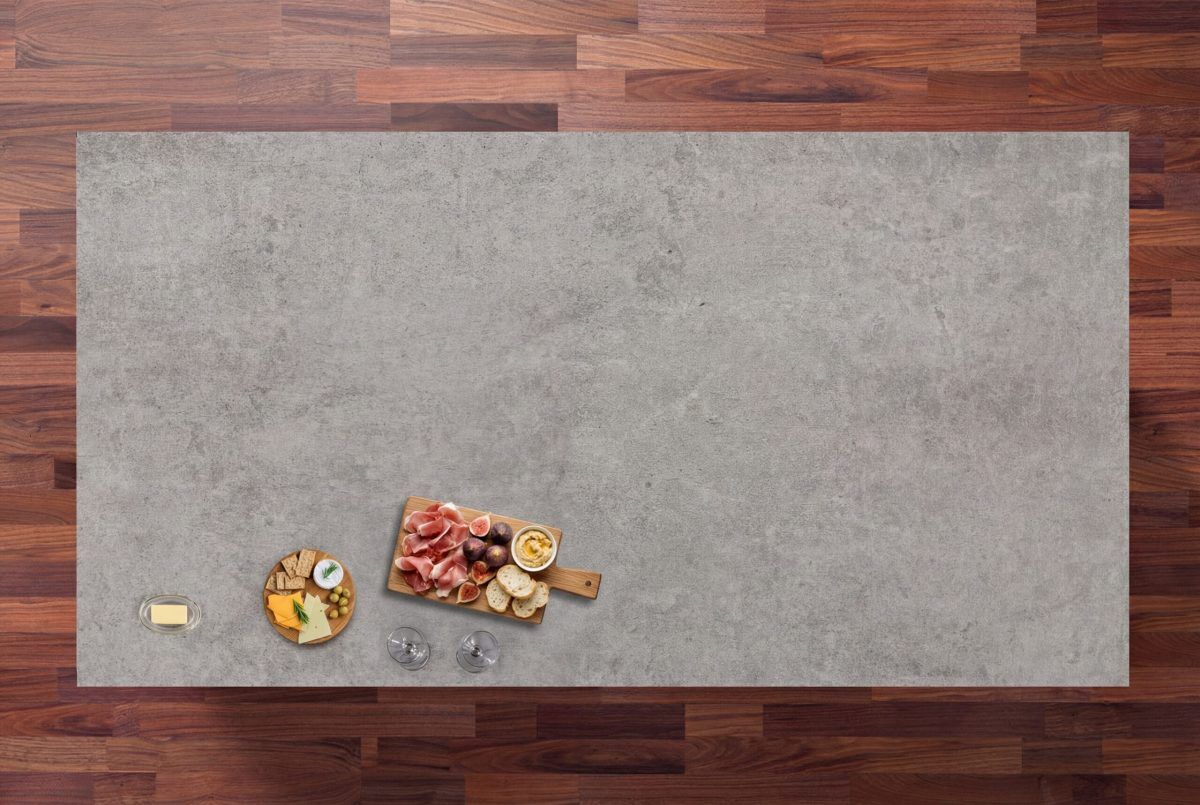 Kreta Porcelain worktop slab with concrete effect finish shown in an overhead kitchen styling