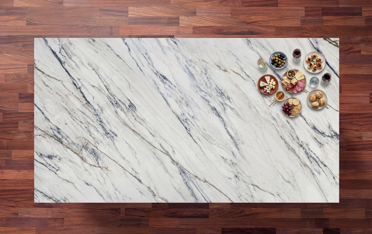 Trance Porcelain worktop surface in white with bold grey veining, photographed from above with small bowls at the edge