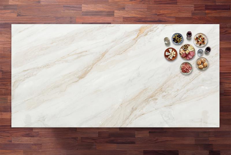 Fusion Gold Porcelain worktop shown from above with soft gold veining on a light base and small bowls placed in the corner