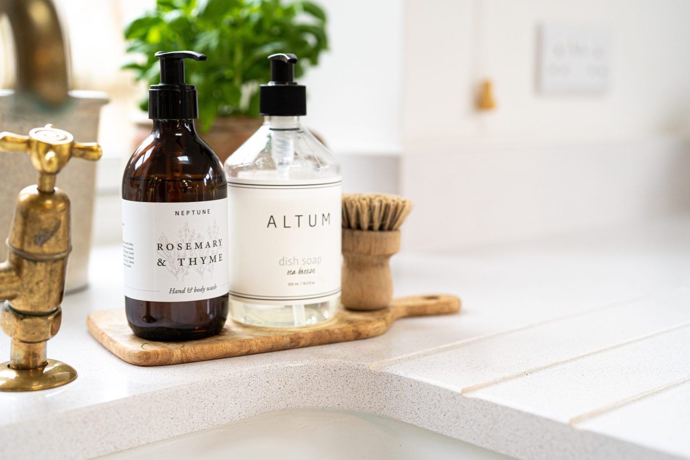 Ice White Quartz worktop close-up with drainer grooves and kitchen bottles on the surface