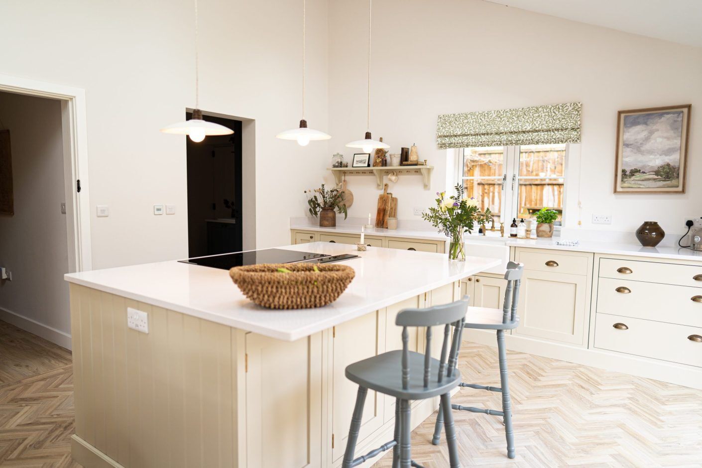 Open-plan kitchen view with Ice White Quartz island worktop and seating, showing a smooth bright surface