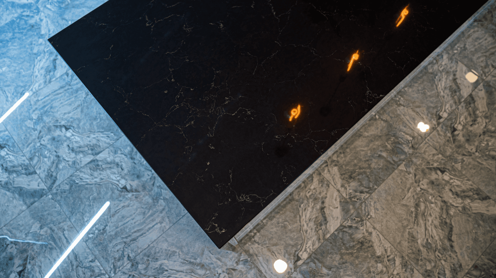 Emperor Black Quartz worktop corner shown from above with subtle pale veining on a polished black surface