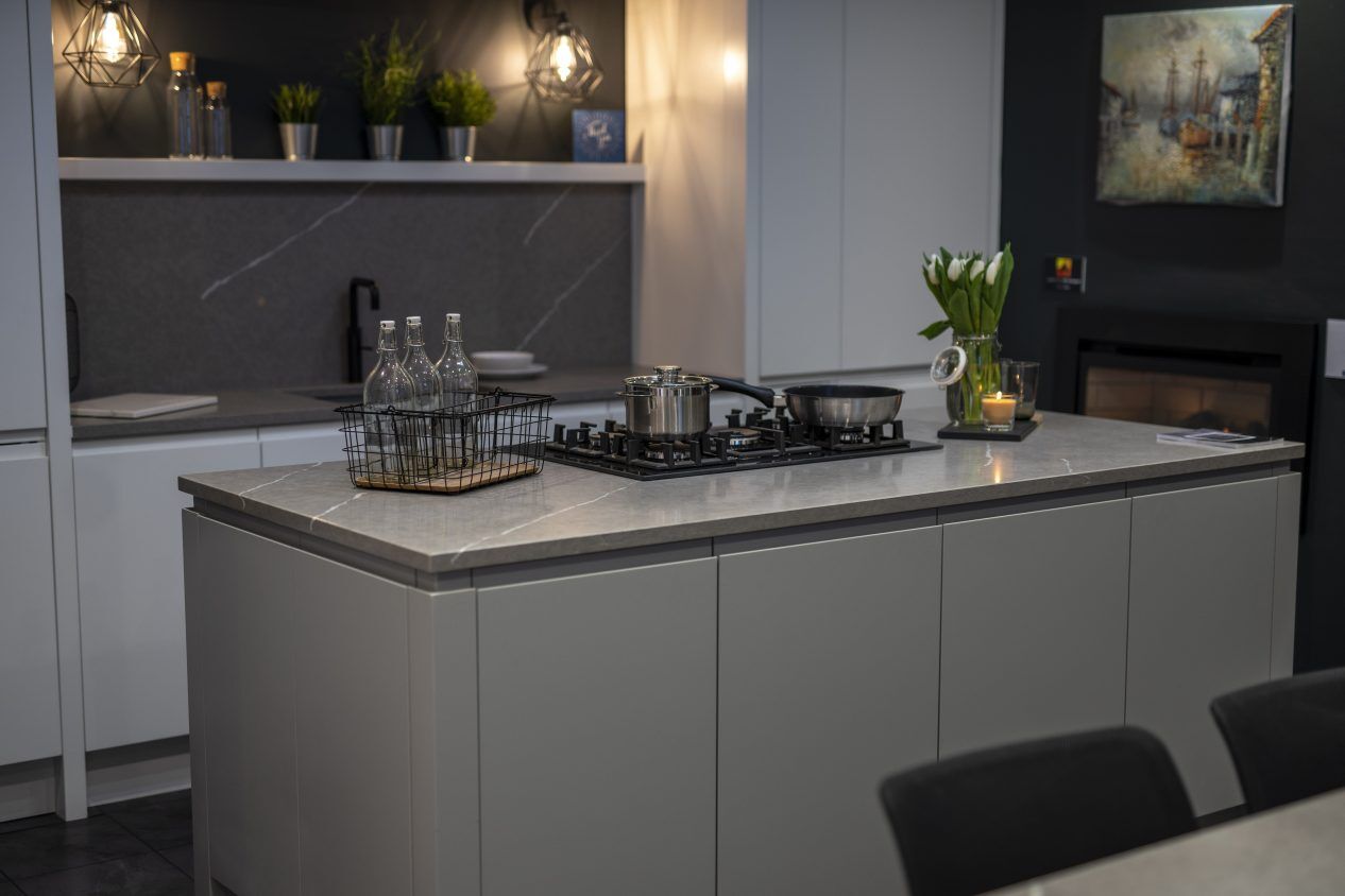 Pietra Grey Quartz worktops on a modern island with dark grey stone-effect surface and fine white veining