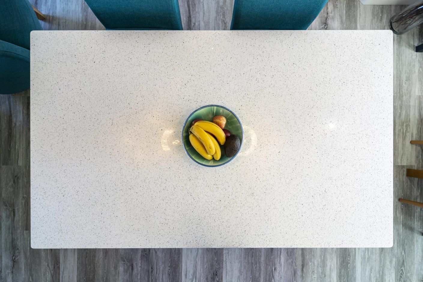 White Starlight Quartz worktop surface styled with fruit in a bright kitchen setting