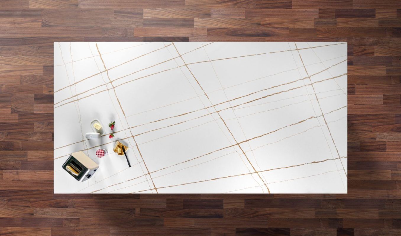 Sahara White Quartz worktop shown from above with fine grey lines and warm gold veining across a bright white surface