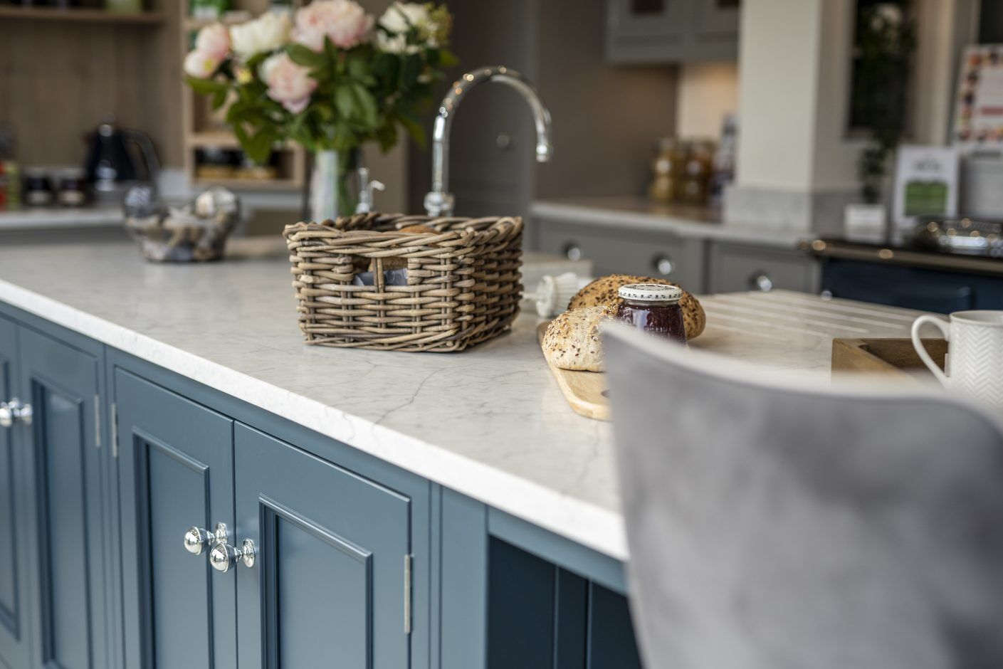 Super White Quartz worktop edge detail on blue cabinetry showing a smooth stone-effect surface beside the sink area