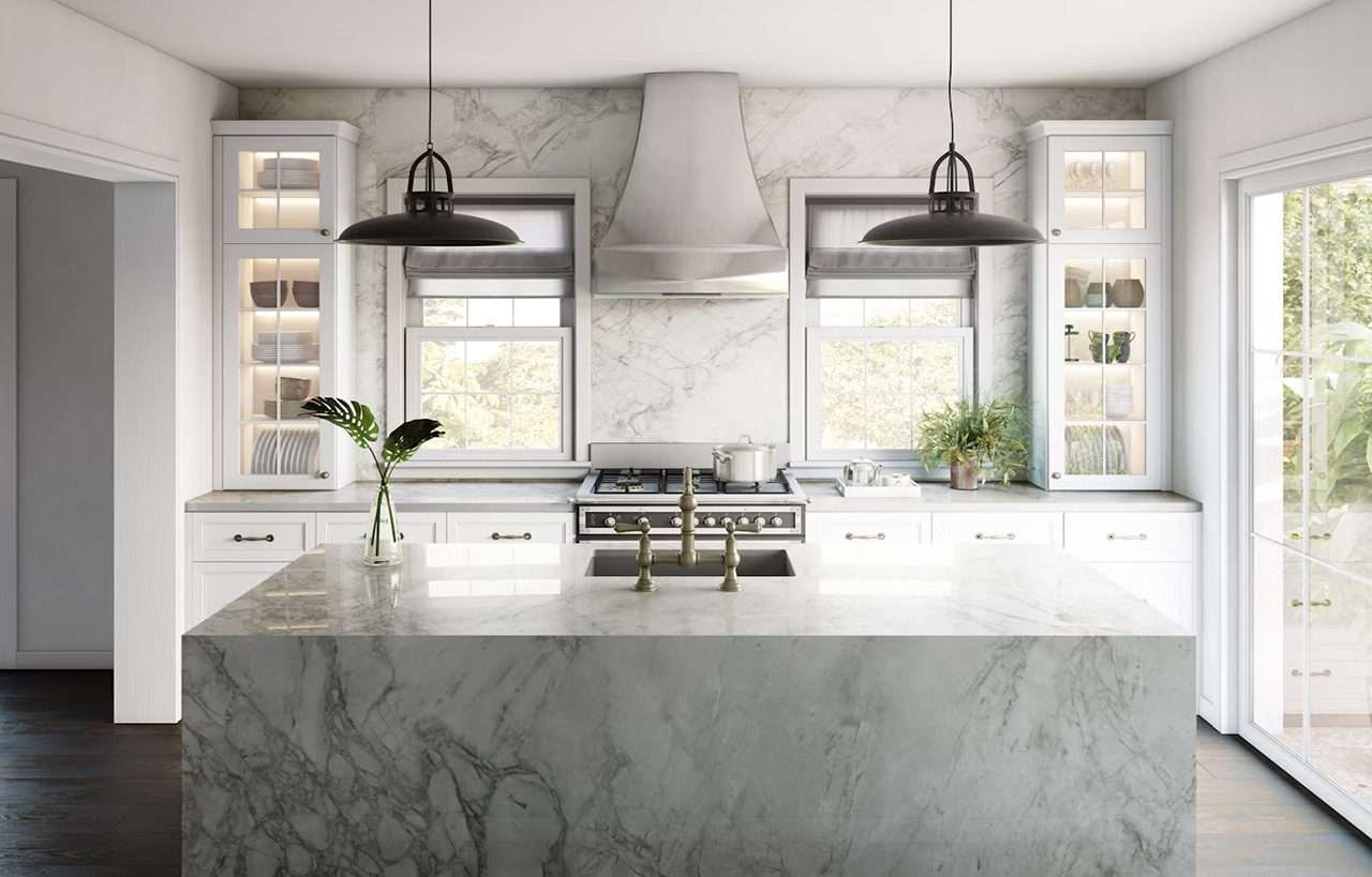 Bergen Porcelain island with a light stone effect and soft grey veining, shown as a waterfall edge centrepiece in a bright kitchen