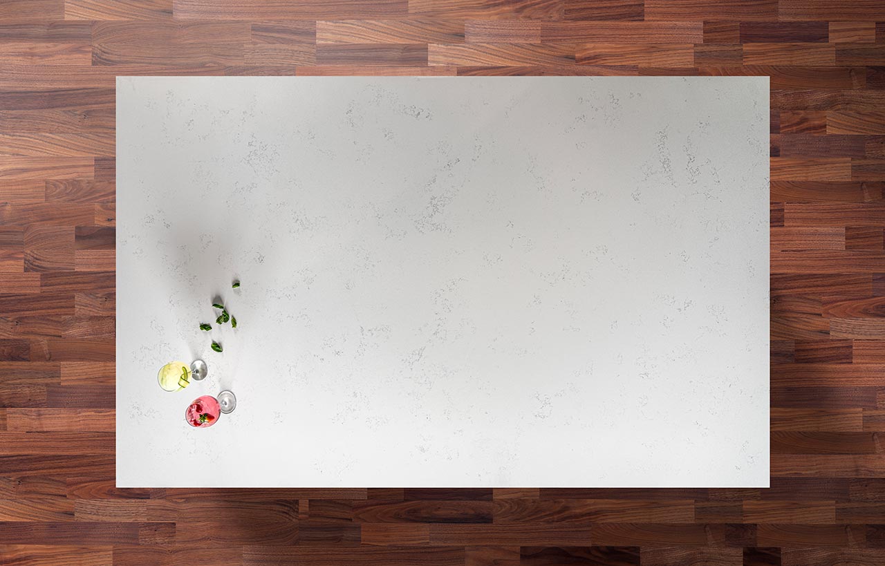Overhead view of Bluetta Carrara Quartz worktop showing subtle grey veining across a bright surface