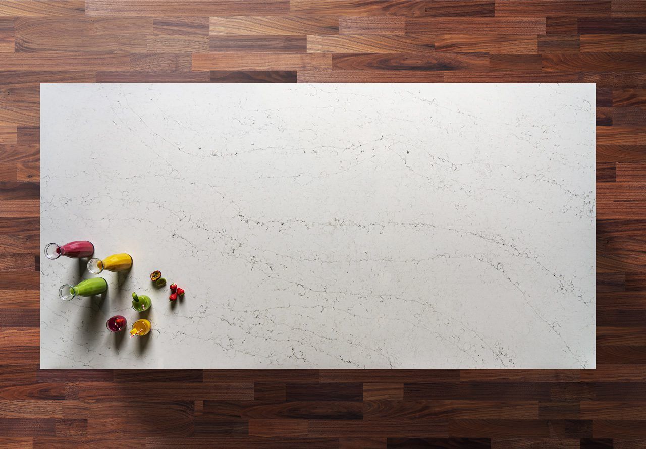 Eternal Carrara Quartz worktop shown from above with soft grey veining and fine speckling across an off-white surface