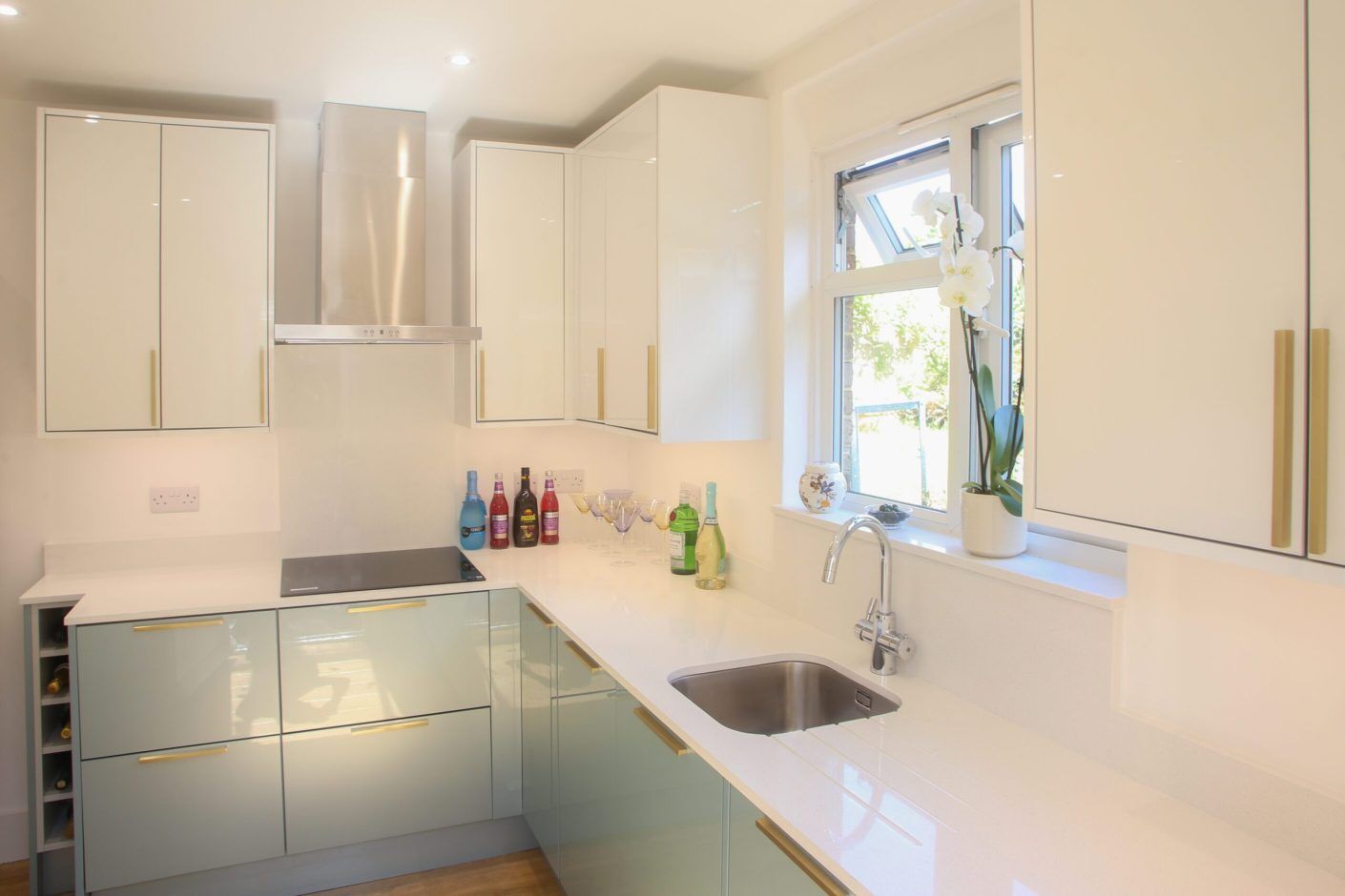 Dover White Quartz worktop in a bright kitchen with an undermount sink and smooth white surface finish