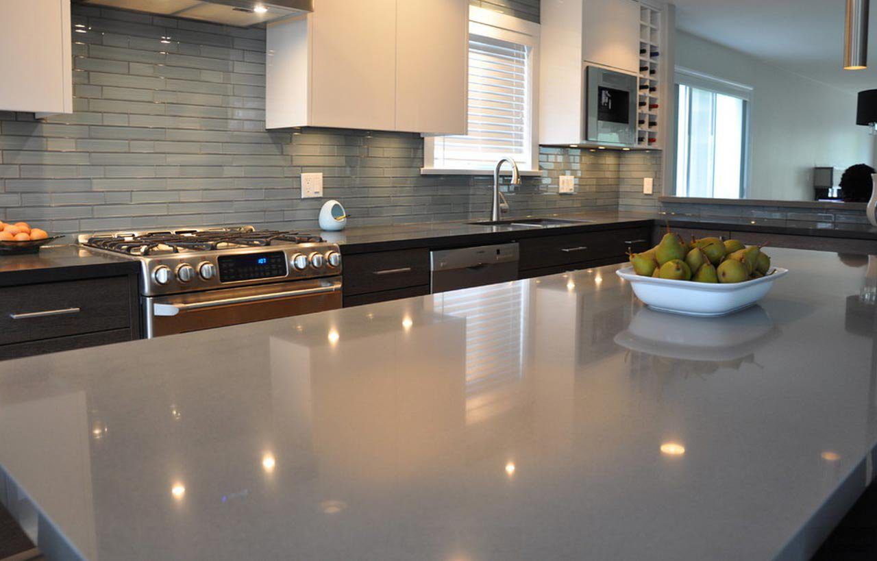 Gris Expo Quartz worktops in a modern kitchen showing smooth mid-grey surface with a polished finish