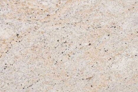 Close up slab photo of Ivory Fantasy Granite showing light beige tones with fine speckling and natural colour variation.