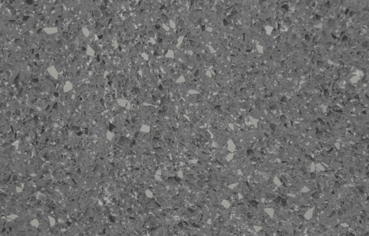 Platinum Quartz slab close-up showing dark grey base with scattered lighter aggregate flecks throughout the surface