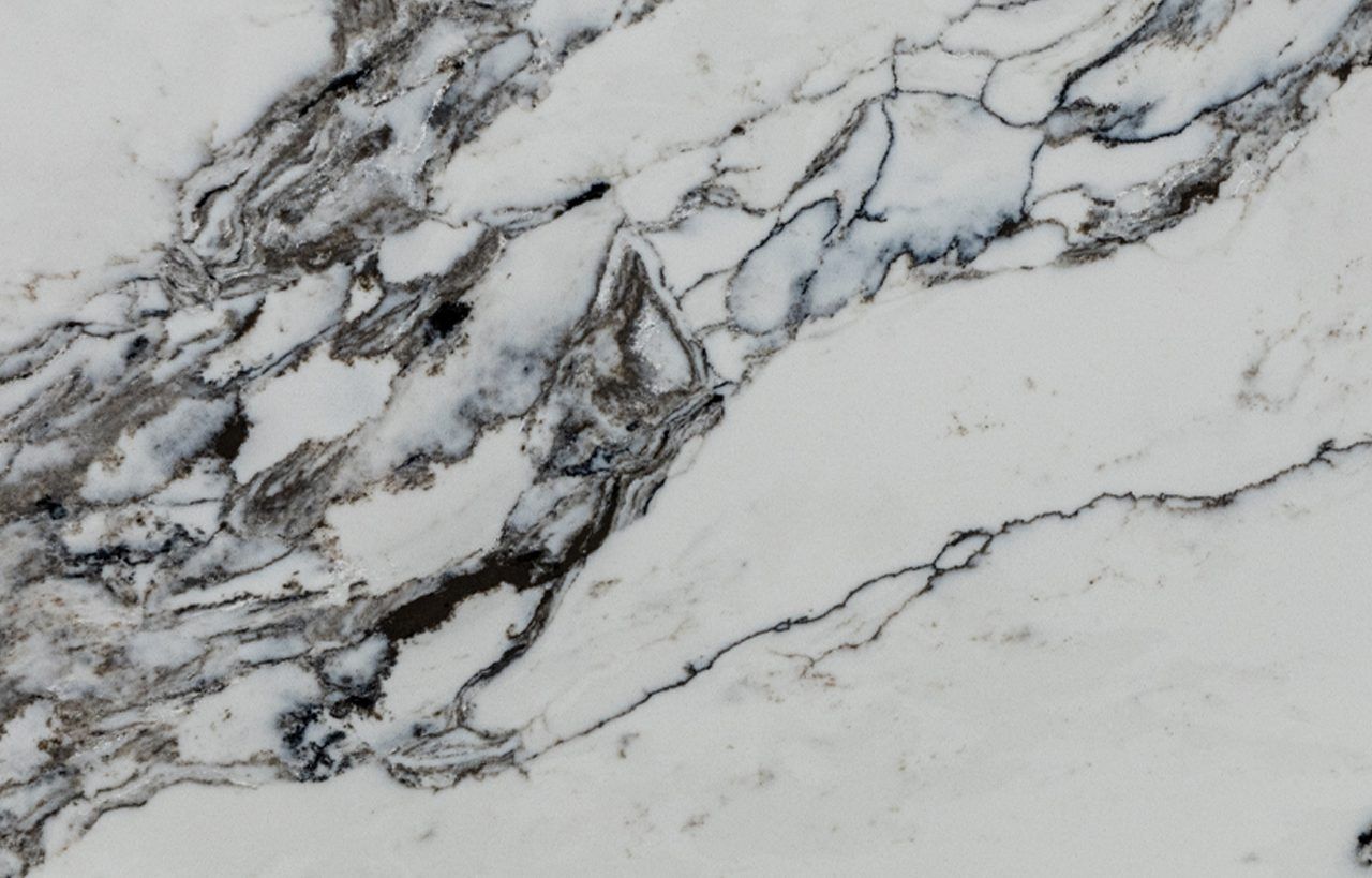 Ivory Calacatta Quartz close-up showing dense grey veining and fine linework on a bright white marble-effect surface