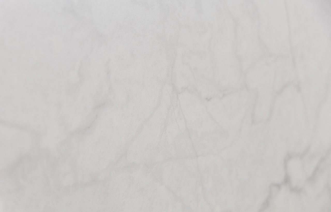 Statuario Venato Porcelain close-up with soft, low-contrast veining across a light white surface.