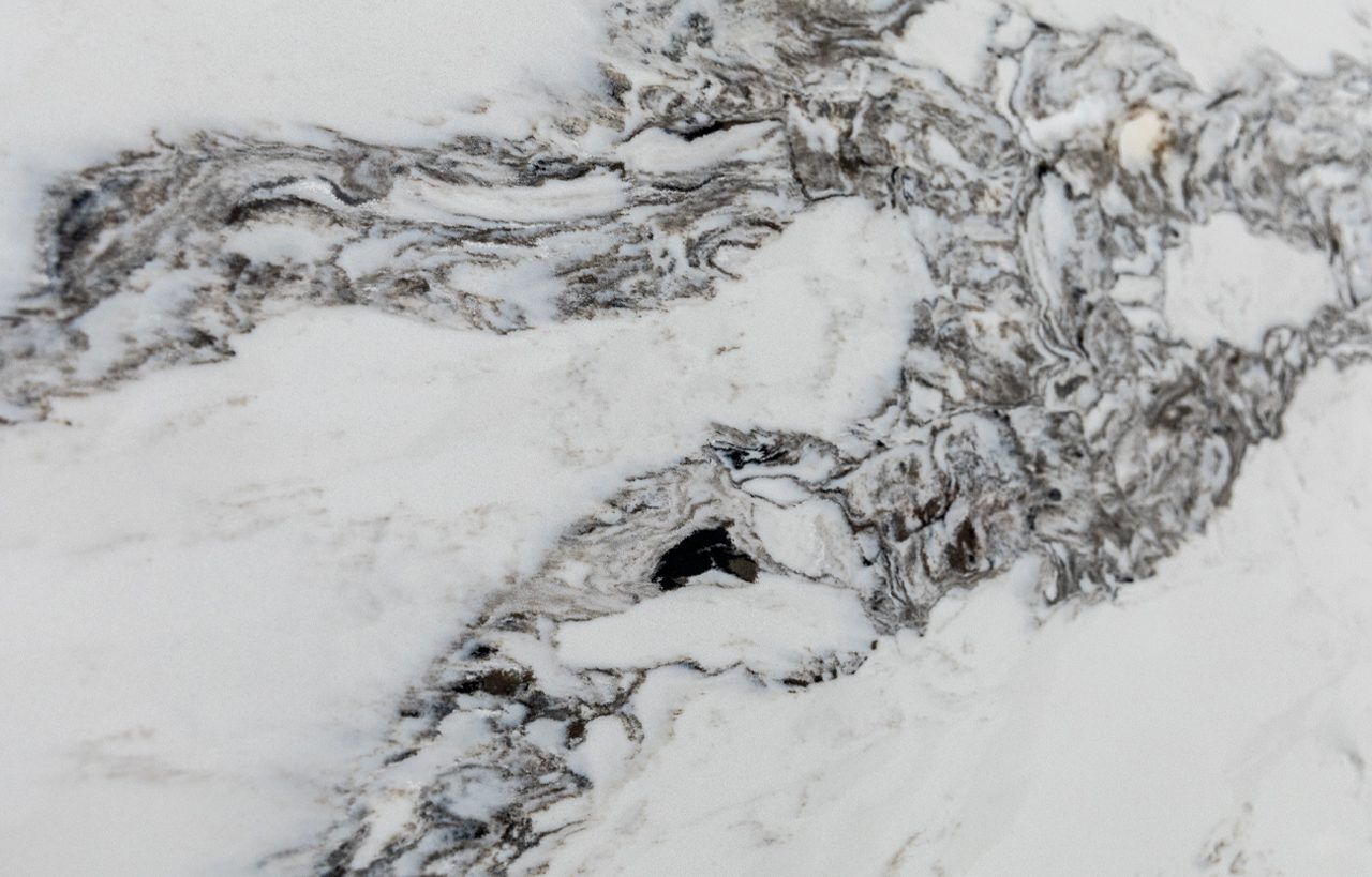 Ivory Calacatta Quartz slab close-up with bold grey marbling and high-contrast movement across a white surface