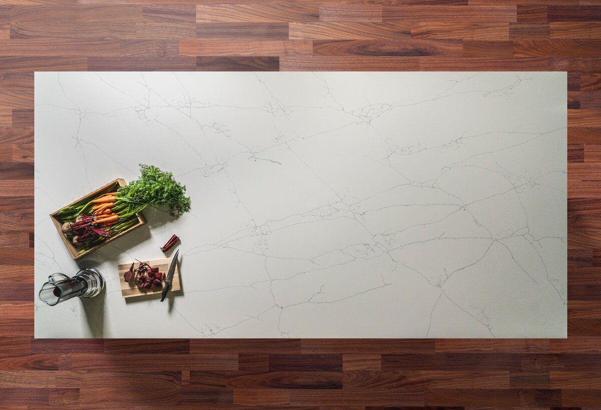 Overhead view of White Macaubus Quartz worktop showing soft grey veining across a bright surface